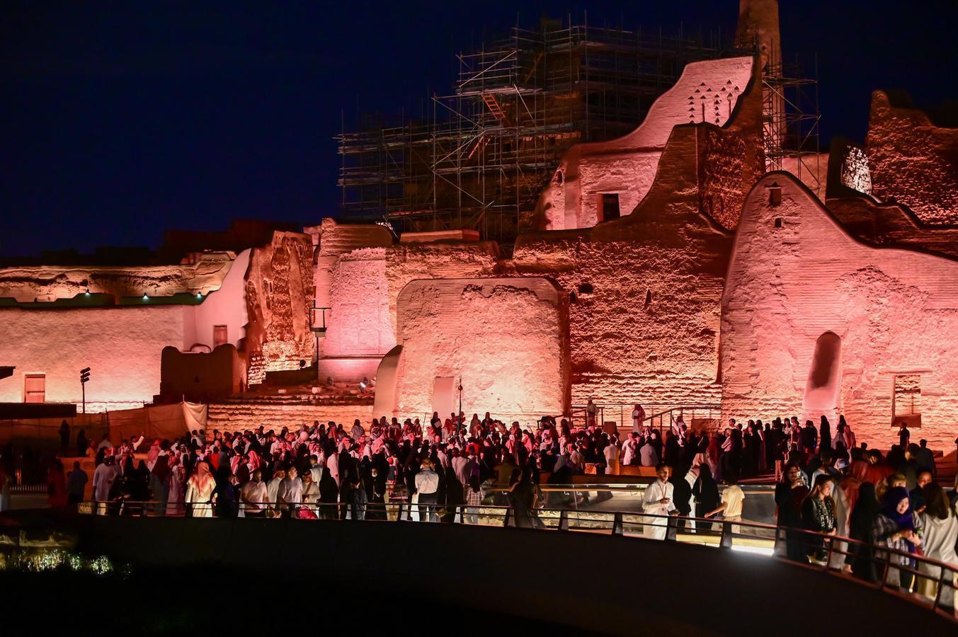 Visitors at Diriyah, a UNESCO World Heritage Site in Saudi Arabia, highlighting cultural heritage and modern development in Saudi tourism.