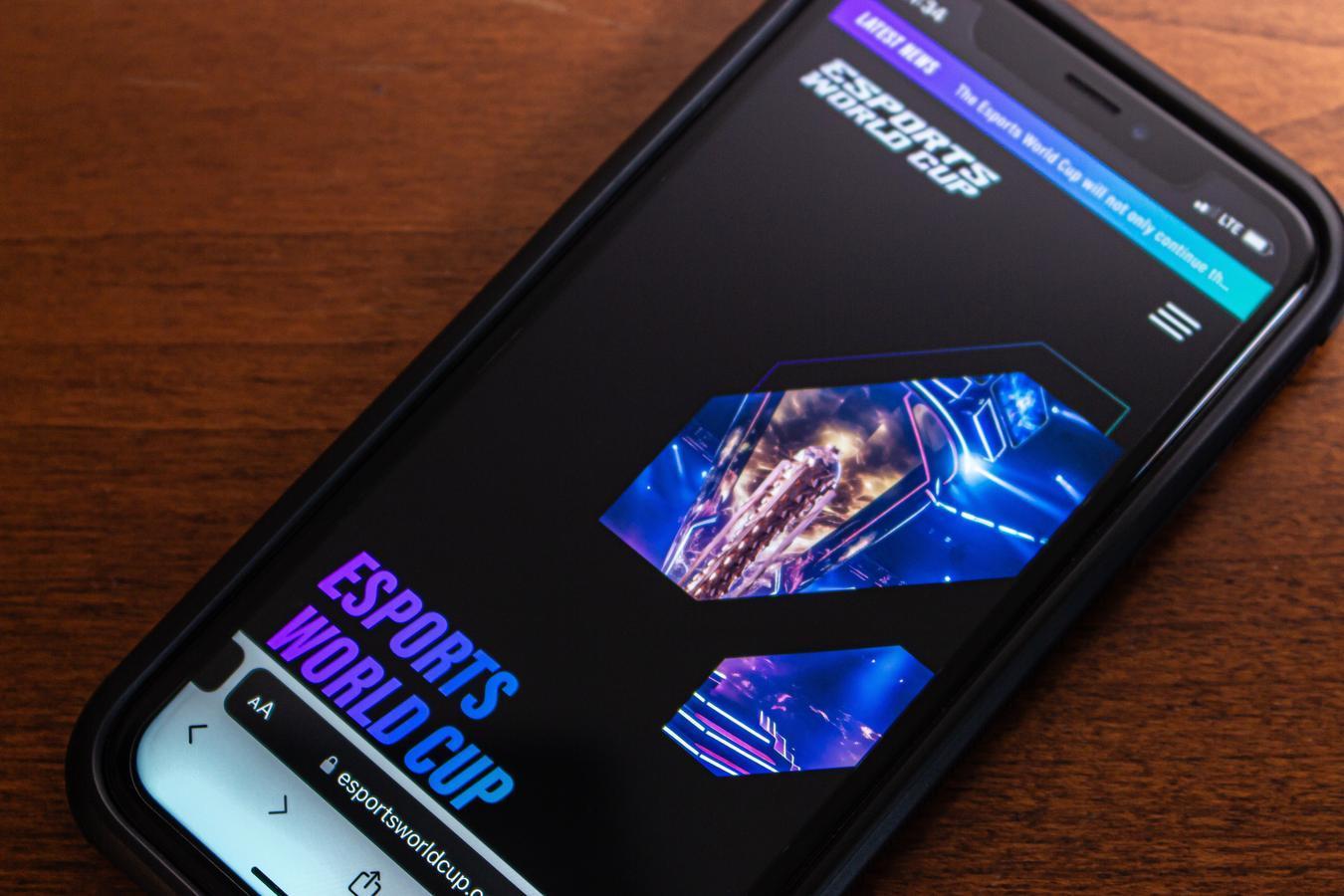 A smartphone screen showing the Esports World Cup website, highlighting the modern digital engagement and the rising prominence of competitive gaming worldwide.