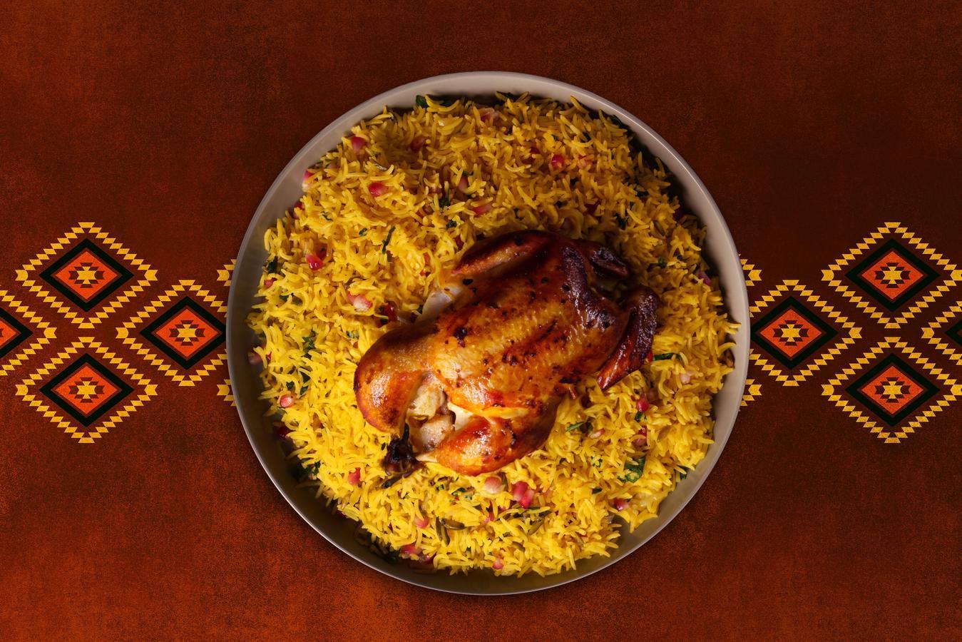 Saudi Arabia's national dish, chicken kabsa, served with roasted chicken and almonds, also known as mandi.