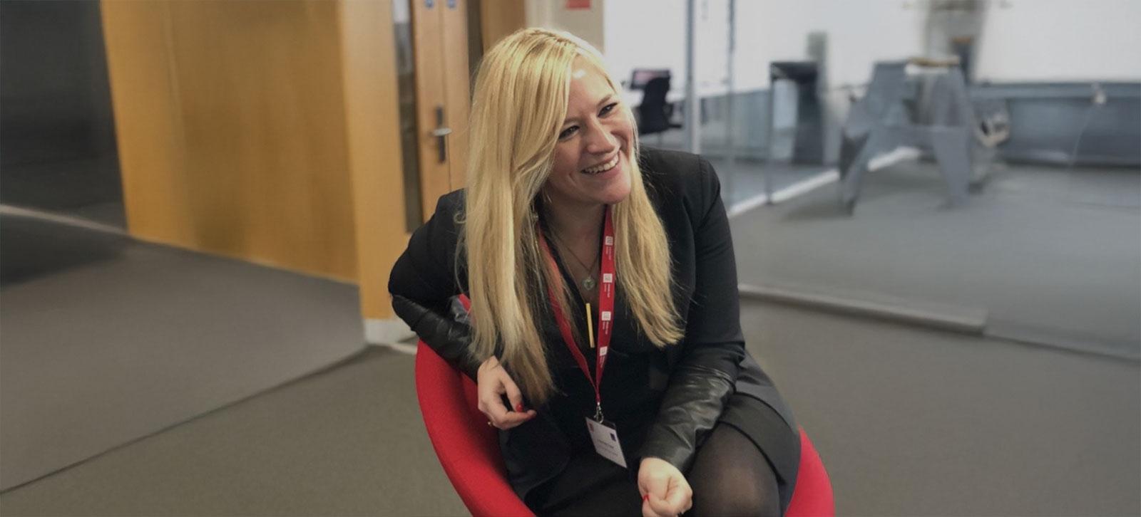 Courtney Freer, a scholar of Gulf politics and Islamism, smiling while seated in an office setting during an academic interview.