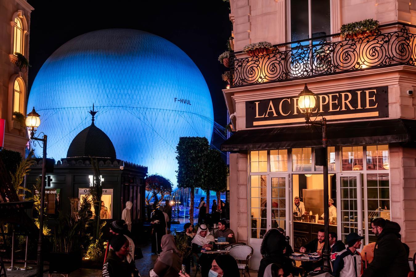 Public entertainment district at Boulevard World in Riyadh, Saudi Arabia, with visitors walking through an open urban space.
