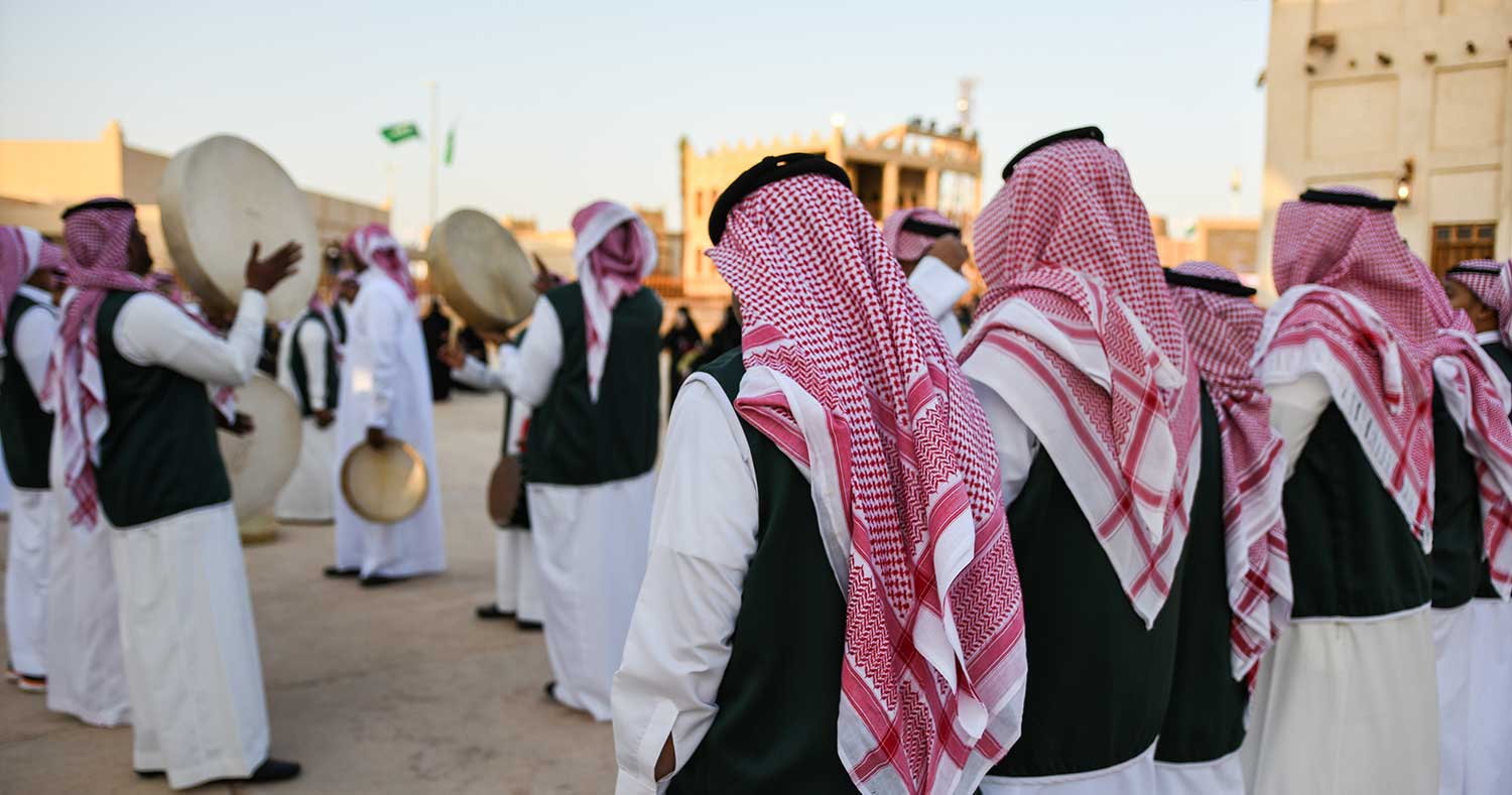 Riyadh, Saudi Arabia: Janadriah Festival. A group of men perform a traditional Saudi Arabian dance and singing (Image Source: Shutterstock)