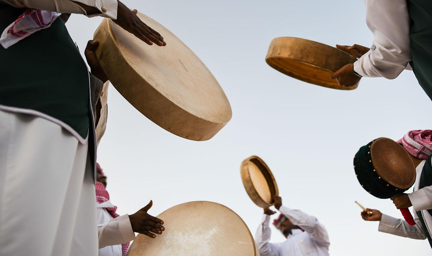 Riyadh, Saudi Arabia: Janadriah Festival. A group of men perform a traditional Saudi Arabian dance and singing (Image Source: Shutterstock)